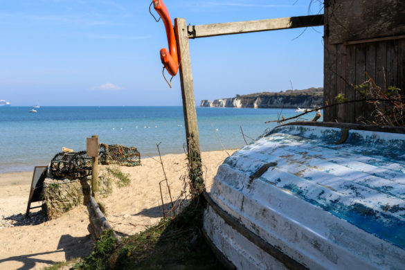 Boat, life vest and lobster pots at South Beach, Studland