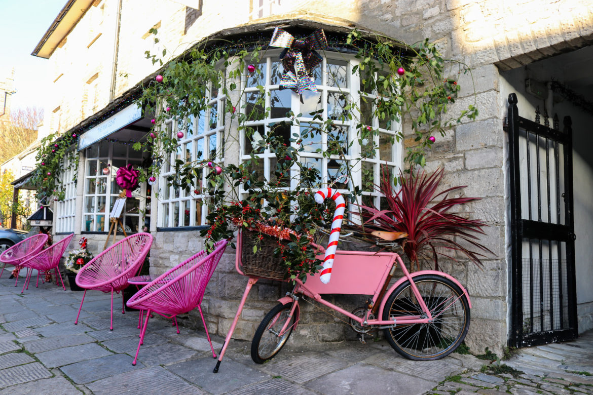 Pink furniture and bicycle outside the Pink Goat café in Corfe Castle
