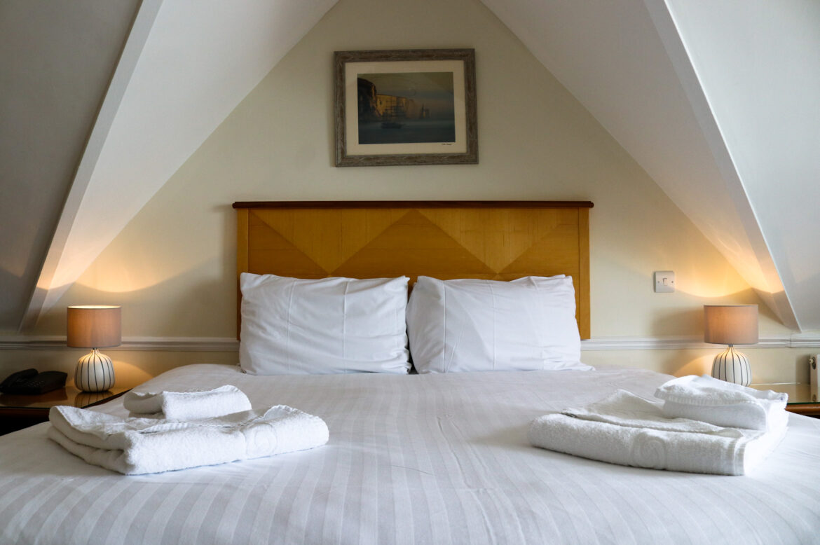 Folded towels on freshly made bed at the Grand Hotel in Swanage