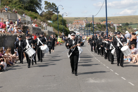 A marching band performing during the Swanage Carnival parade