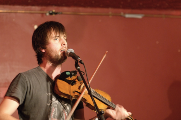 Musician Jon Boden playing the fiddle and singing