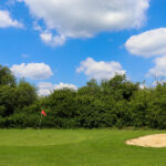 Bunker next to red flag at pitch & putt hole at Swanage Golf Games