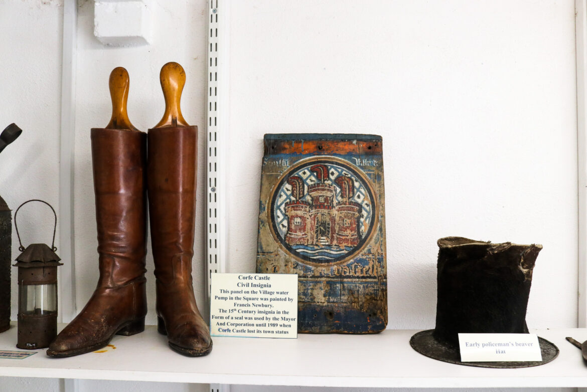 Early policeman's hat and Corfe Castle civil insignia in the village museum