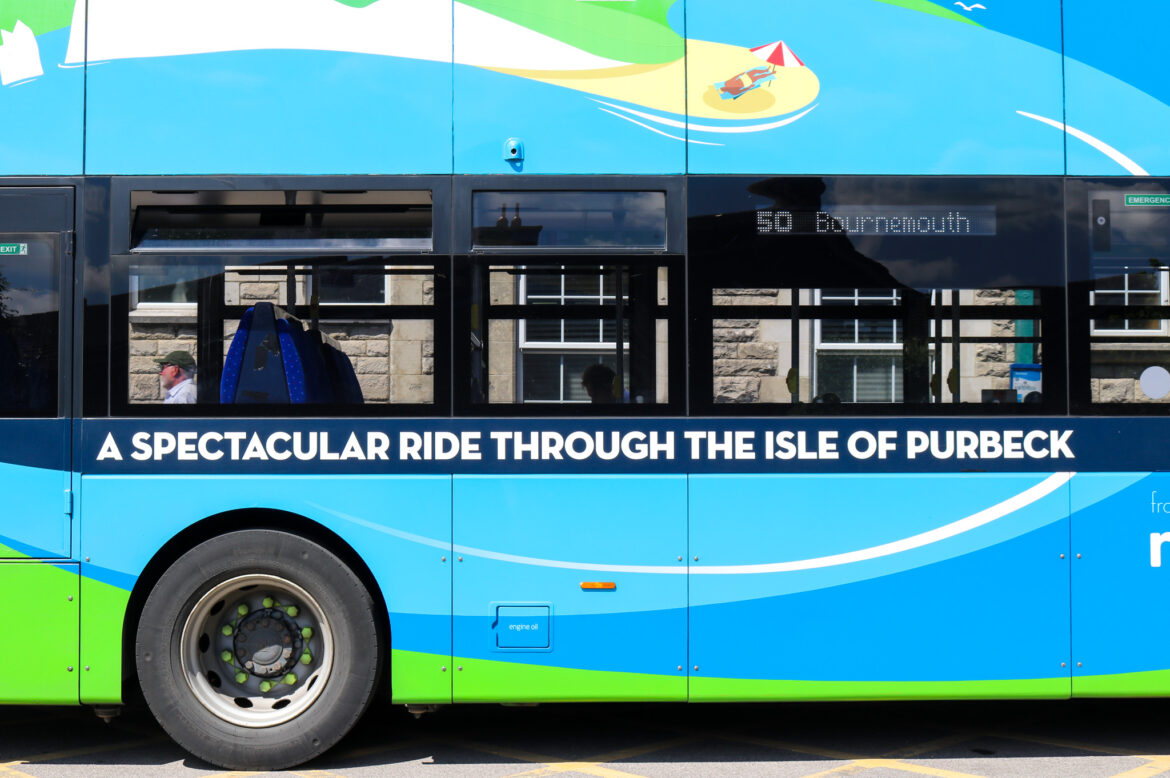 Sign on side of No 50 Bournemouth to Swanage bus - 'A spectacular ride through the Isle of Purbeck'