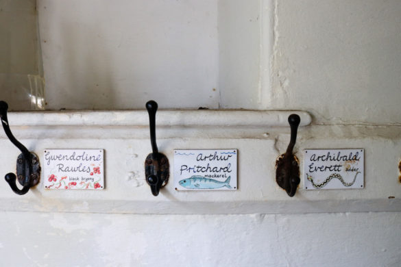 Children's name tags and pegs in the hallway of the Tyneham village school