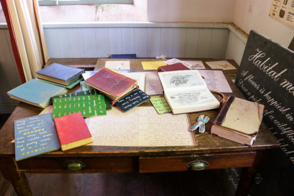 Books and schoolwork on display in younger children's area of the Tyneham schoolroom exhibition