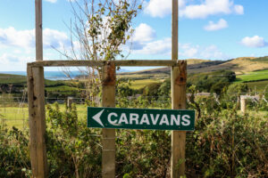 Sign for caravans down the private road leading to the Smedmore Estate and caravan park in Kimmeridge