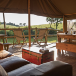 Sofa, table, chairs and decking of one of Knaveswell Farm's Glamping tents