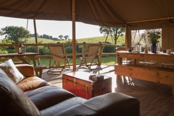 Sofa, table, chairs and decking of one of Knaveswell Farm's Glamping tents
