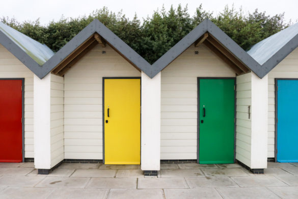 Red, yellow, green and blue doors on Swanage's Shore Road beach huts