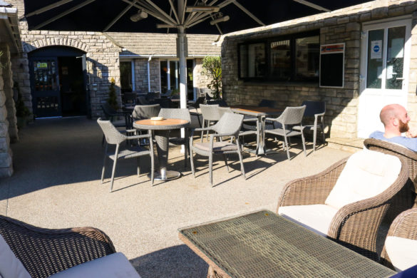 Outdoor tables and chairs at The Village Inn pub, Swanage