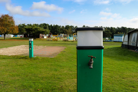 Water taps next to hardstanding pitches near the playground at Birchwood Tourist Park