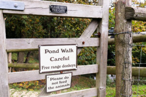 Pond walk with free range donkeys sign on a gate in East Creech
