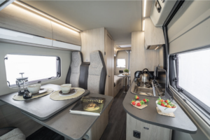 Dining area and kitchenette inside a van conversion for hire with Go Solent Motorhome Hire