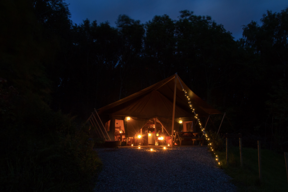 Twingling fairy lights outside a safari tent, Knaveswell Farm