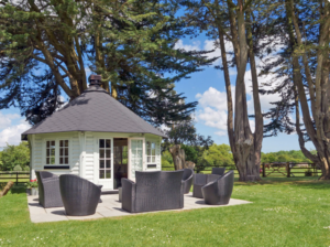 Outdoor, all-weather pavilion and seating in the garden of Norden House