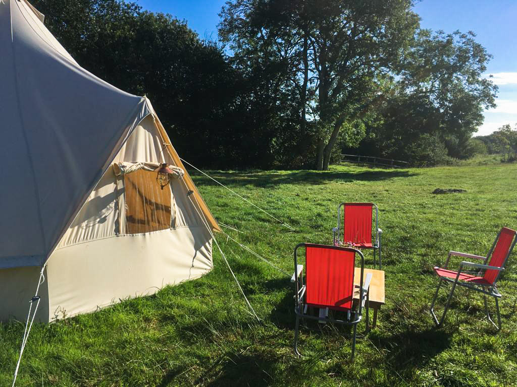 Camping chairs outside bell tent at Steeple Leaze Farm Campsite