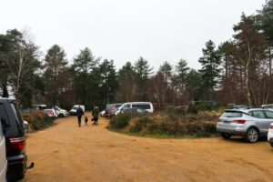 People walking through the car park at Wareham Forest's Sika Trail