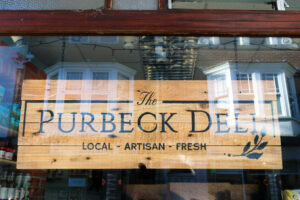 Purbeck Deli sign in the store's window on Institute Road