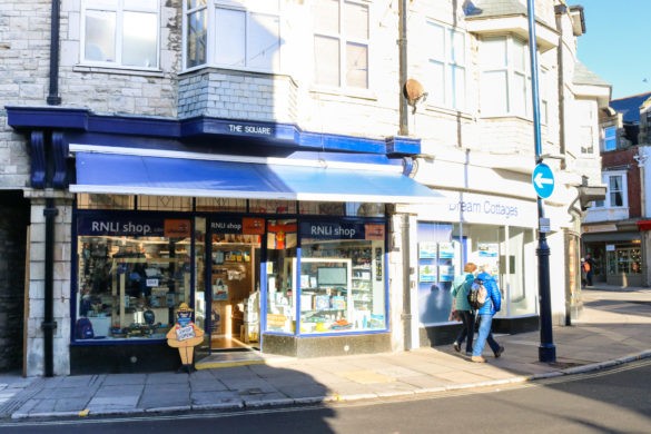 People walking past the RNLI shop toward Institute Road in Swanage