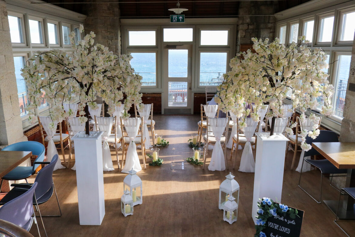 Flowers and seating for a wedding in Durlston Castle's Belvedere Room