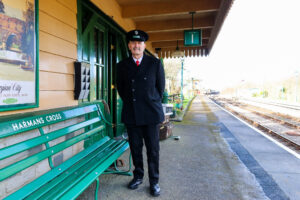 A porter waiting for the steam train, Harman's Cross railway station