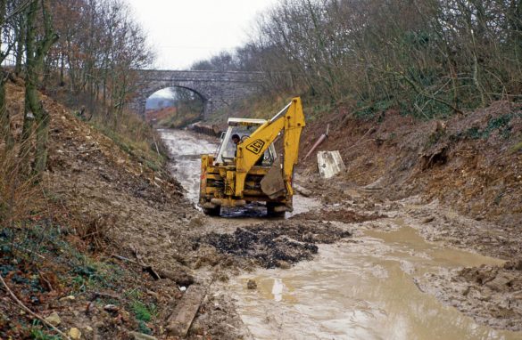 JCB digger in the mud at the creation of Harman's Cross train station