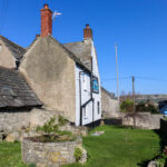 Blue skies and glimpse of the Purbeck Ridgeway outside the Black Swan Inn, Swanage