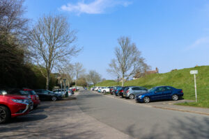 Cars parked by the Wareham Walls at Streche Road car park