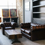 Leather sofa seating area and fruit machines int he bar of Swanage Bay View Holiday Park