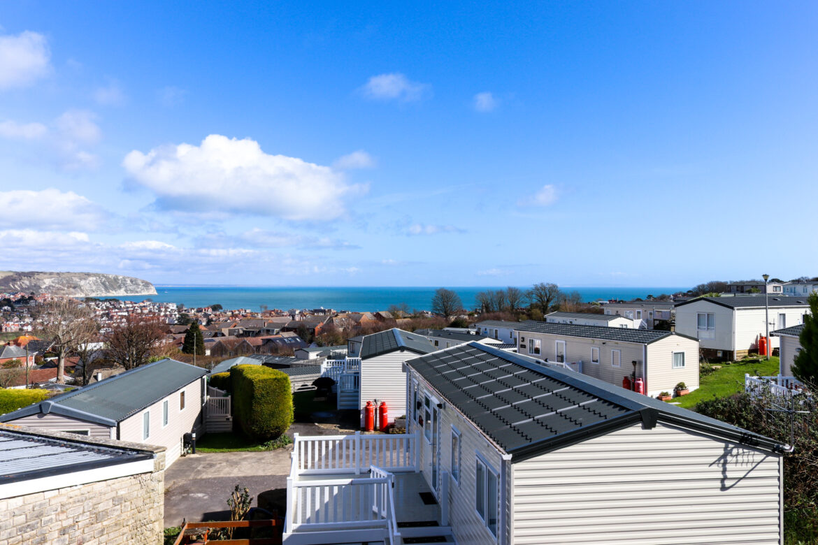 view of the sea across caravan rooftops at the Swanage Bay View Holiday Park