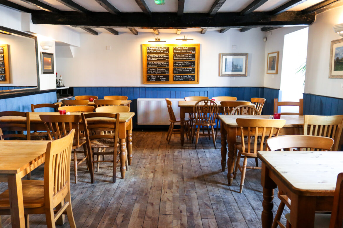 Tables & chairs in the restaurant area of Swanage’s Black Swan pub