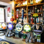 Lager, cider and beer taps on the bar of the Black Swan in Swanage
