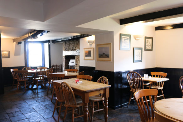 Tables & chairs in the main bar area of Swanage’s Black Swan Inn