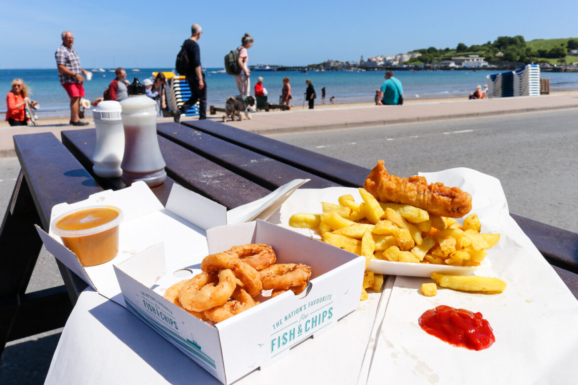 Onion rings, sausage in batter, chips & curry sauce from Wright on the Beach