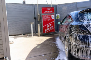 A car having jet spray wash at Swanage's petrol station