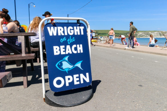Open sign outside Wright on The Beach, Swanage