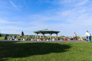 People gathering t the bandstand in Swanage to watch a summer performance