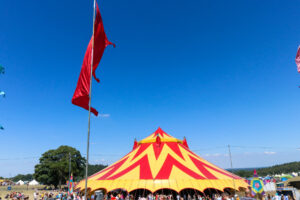Yellow & red traditional 'big top' tent at Camp Bestival