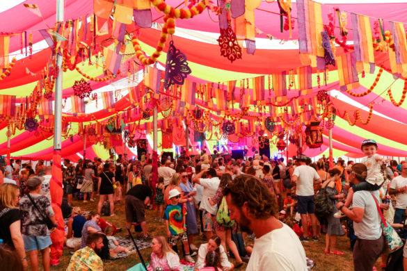 People listening to music in the Bollywood tent, Dorset's Camp Bestival