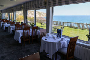 Dining tables with sea views at Swanage's Pines