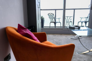 Orange armchair in Pines Hotel Swanage bedroom