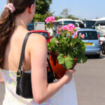 Person buying flowers at Swanage Market